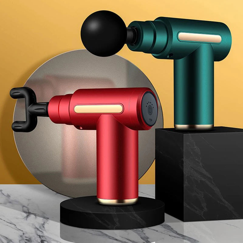 Red and green massage guns on a marble surface with a yellow background