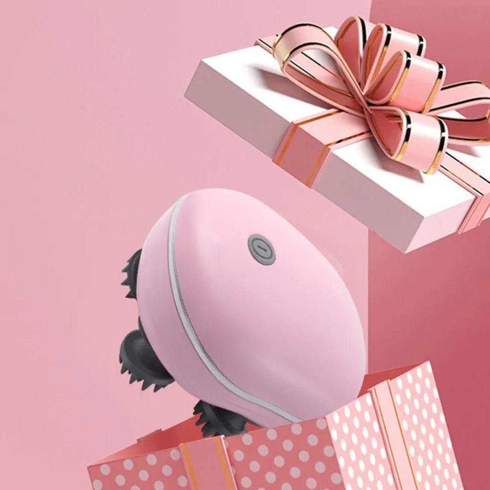 Pink handheld device with black bristles on a pink background with a gift box and bow.