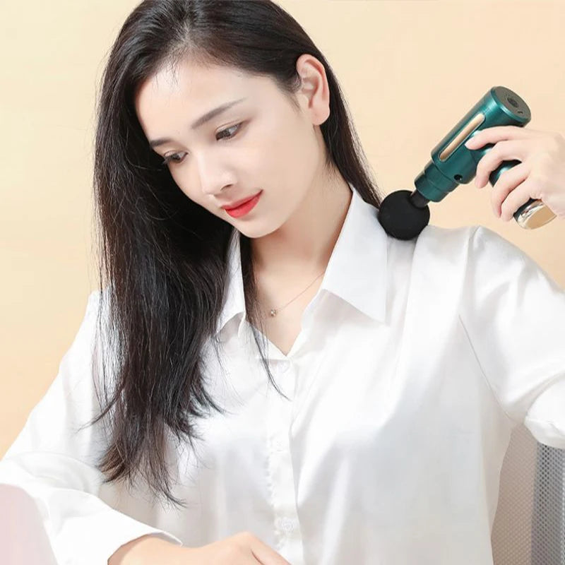 Woman using a handheld device on her neck against a beige background