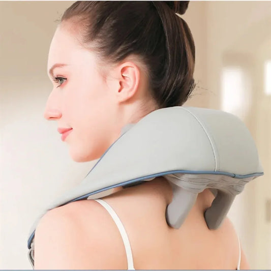 Woman using a neck and shoulder massager on a neutral background آلة التدليك