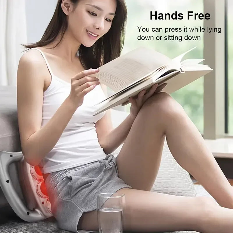Woman reading a book with a massage device on her back, text indicating 'Hands Free' and usage information.