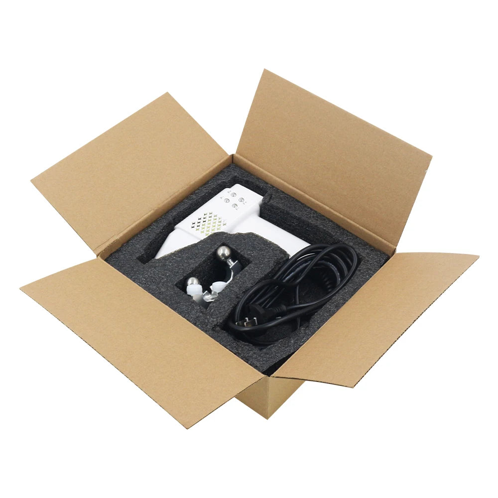 White electronic device with black cable in an open cardboard box on a white background
